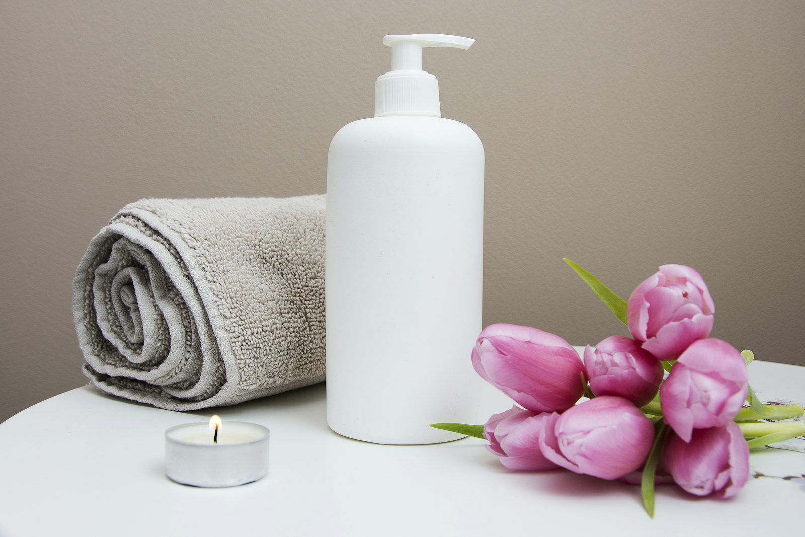 A calm spa treatment room dressed in cream linen